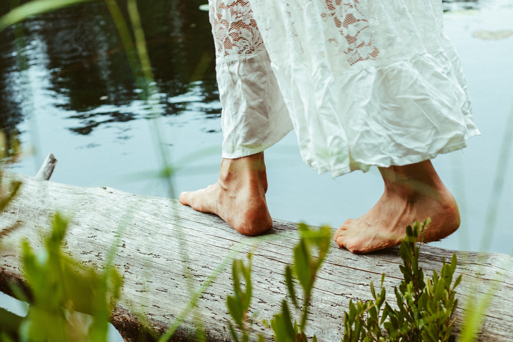 Woman's feet near the lake